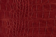 Red alligator or reptile skin of high quality and high resolution. Texture and background of crocodile or alligator dark red skin in square pattern for wallets, purse, bags and interior design.