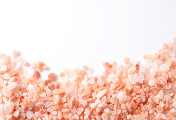 Pink rock salt placed on white background