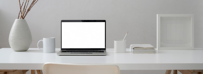 Sticker - close up view of minimal worktable with mock-up laptop, mug, supplies and decoration with chair