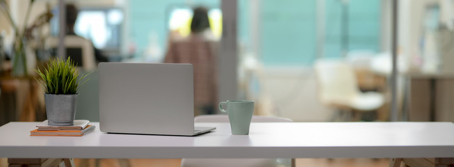 Sticker - close up view of comfortable office desk with laptop, mug, tree pot, office supplies and copy space