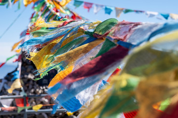 Prayer flags and stupa at the peak of Shika Snow Mountain or Blue Moon Valley, landmark and popular for tourists attractions in Zhongdian city (Shangri-La). Yunnan, China. Asia travel concept