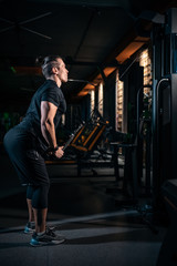 Wall Mural - young athlete has physical workout with barbell in modern gym