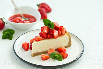 Wall Mural - Slice of cheesecake with strawberries, mint and sauce. Selective focus