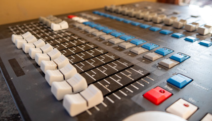 Sound mixer control panel with sliders and buttons closeup. Selective focus.