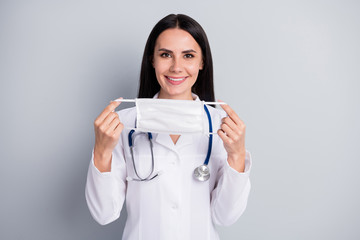 Sticker - Close-up portrait of her she nice attractive lovely confident professional cheerful girl doc holding in hands cotton mask use safe life isolated over grey pastel color background