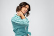 © Syda Productions - people concept - young woman in turquoise shirt suffering from neck ache over grey background