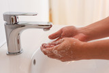 Fototapeta  - Washing hands. Water is running from the faucet. Water Tap. Hygiene.