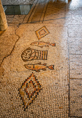 Tabha, Israel, Ancient mosaic, image of two fish and five loaves. Church of the Multiplication of Bread and Fish (Tabha) The concept is the history of Christianity.