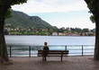 © Raul Baldean - Tourist resting on bench looking at the lake