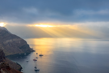 Rays of the Sun Through Heavy Clouds Over the Caldera of Santorini