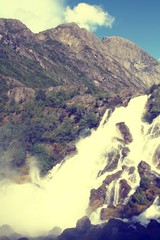 Sticker - Norway waterfalls. Retro color filtered style.