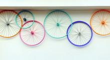 Old Bicycle Wheels Colorful On The Wall Of A Rental And Repair Shop, Hipster Decorative Trend Concept