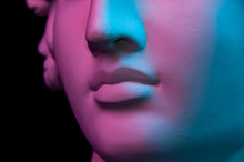 Colorful Gypsum Copy Of Ancient Statue Of Human Head For Artists On A Black Background. Close Up View Lips. Plaster Sculpture Of Human Face. Toned Blue And Purple. Webpunk, Surreal Style Poster.
