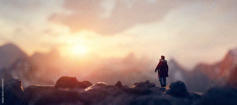 Man on the peak of mountain looking at sunset sky. Trip and adventure. Inspirational. - obrazy, fototapety, plakaty 