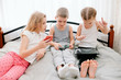 © Валентина Свиридо - Group of three young people using smartphones together, modern lifestyle or communication technology gadget concept