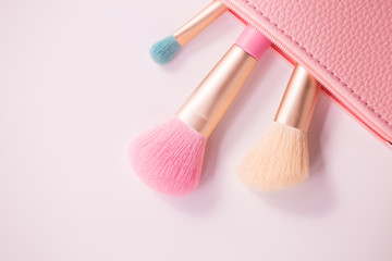 Make up brushes with powder on white background