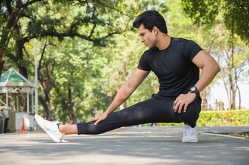 Young fitness man runner stretching before run. Healthy fitness, workout, sport, lifestyle and sport concepts