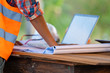 © visoot - Engineer working with laptop and blueprints,engineer inspection in construction site for architectural plan,sketching a construction project.