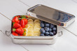Blueberries, bananas and strawberries in plastic free container.