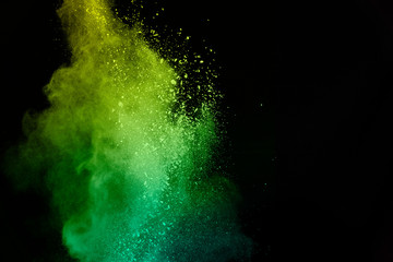 Wall Mural - green powder explosion isolated on Black background.Colored dust splash isolated.