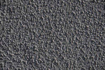 Grey rough texture painted wall background. Cement texture close up. Decorative plaster grey wall.