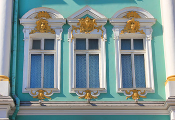 Ornamental historic windows design on Winter Palace building facade in St Petersburg, Russia. Three beautiful decorative windows, old classic exterior elements of historical Winter Palace architecture