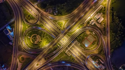 Wall Mural - Time lapse Aerial view and top view of traffic on city streets in Bangkok , Thailand. Expressway with car lots. Beautiful roundabout road in the city center.