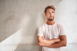 © Westend61 - Portrait of young man wearing t-shirt looking up