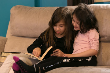 Cute Little Sisters Reading the Holy Bible