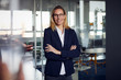 © Westend61 - Portrait of smiling businesswoman in office