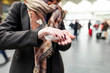 © Westend61 - Woman using sanitising hand gel at train station