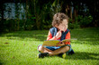 © Hermes Bezerra  - Menino brincando com livro no gramado