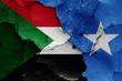 flags of Sudan and Somalia painted on cracked wall