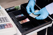 © Andrey Popov - Cashier Working With Register Cash Holding