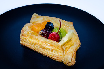 Fruit pastry in black plate