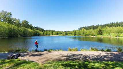 fishing for rainbow trout at lake in park - spring, BC
