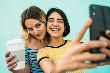 Lovely lesbian couple taking a selfie with phone.