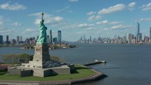 Flying Clockwise Around Statue Of Liberty W NYC In Bkrd