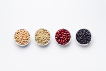 Bean Bowls Top View White Background. These Legumes Are All Pulses (dry Edible Plant Seeds). The Following Ingredients Can Be Seen: Chickpeas, Red Kidney Beans, Green Lentils And Black Turtle Beans.