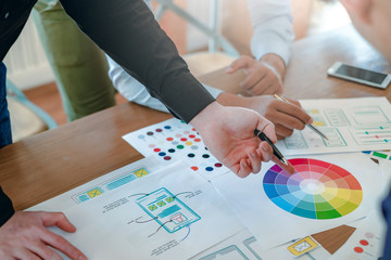 creative web designers and applications work together in the office.