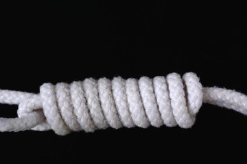 A white rope collection on black background.