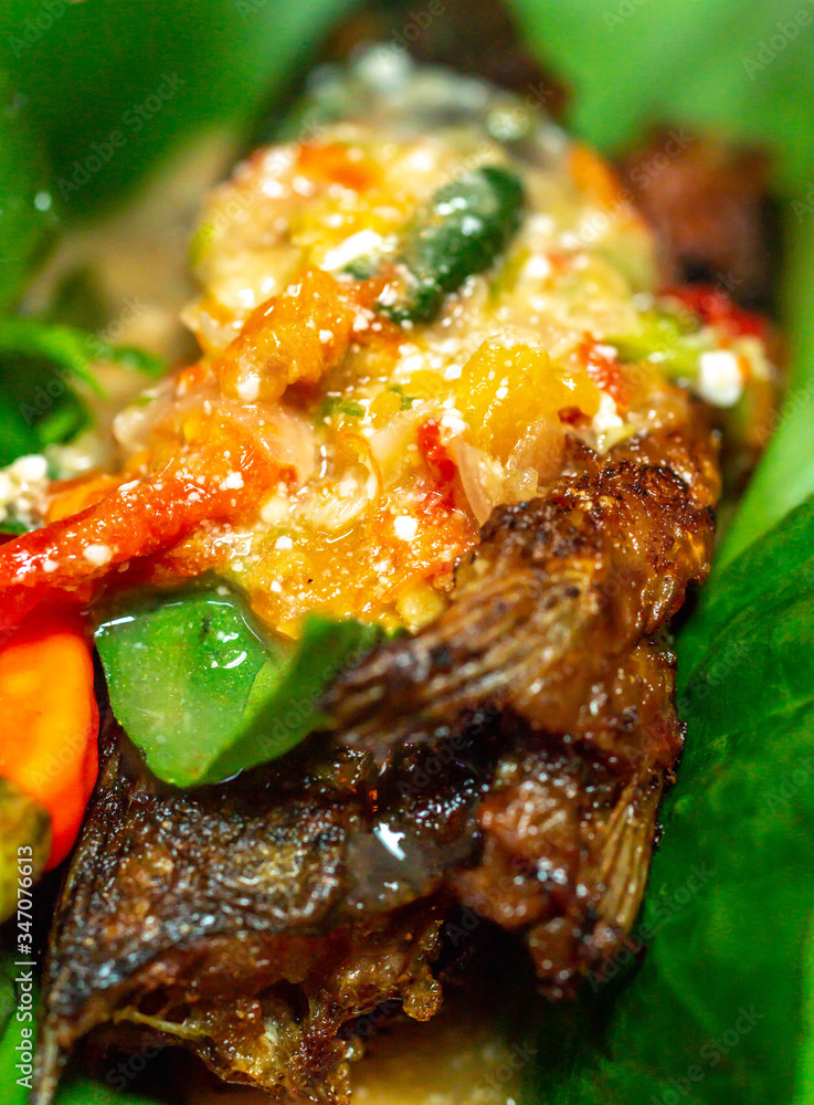 Botok lele, fried catfish served with spicy curry and wrapped with ...