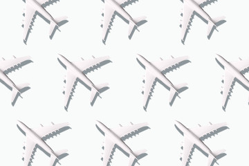 Summer pattern. Creative banner of planes on white background. Travel, vacation concept. Travel, vacation ban. Flights cancelled and resumed again. Top view. Flat lay. Minimal style design.