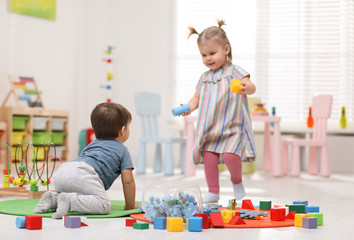 Wall Mural - Cute little children playing together in room