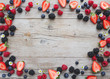 © epiximages - many fresh strawberries, rasperries, blueberries and other fruits on background photo taken from above