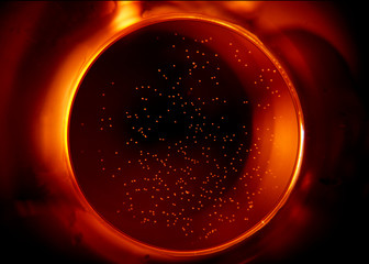 Wall Mural - Shiny abstract sphere in red. Black and red minimalism. Abstract inferno circle in the dark. 