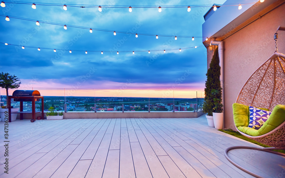rooftop deck patio area with hanging chair on a sunset - obrazy, fototapety, plakaty 