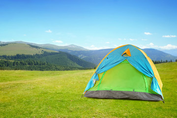 modern camping tent in mountains on sunny day