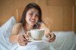 © Songsak C - Asian cute woman drink coffee as breakfast on bed in morning after getting up. Relaxing concept. soft focus, selective focus.