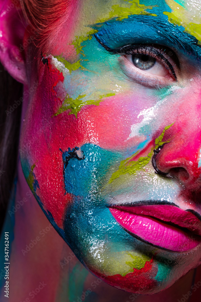 Multicolored skin, difficult to identify. Creative makeup with colorful patterns on the face. - obrazy, fototapety, plakaty 